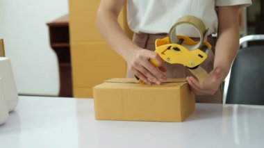 Online small business owners are packing their ordered products into the boxes for their customers based on the concept of online shopping - online shopping.