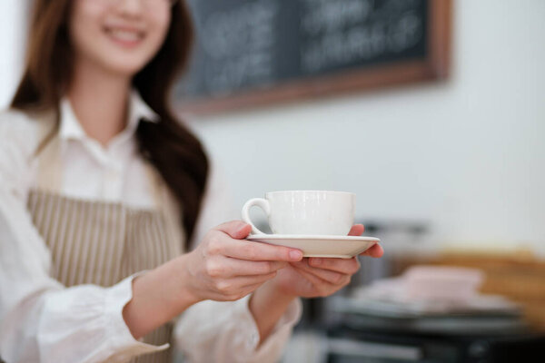 A confident cafe owner holding a coffee cup behind the counter, showcasing dedication to running a successful business. The scene reflects professionalism, hospitality, and customer focus.