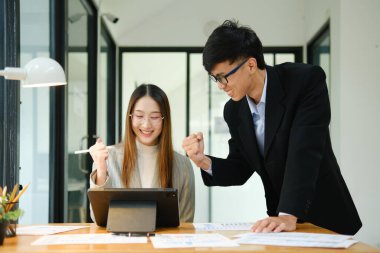 İki işadamı mali raporları birlikte inceledikten sonra başarılı sonuçları kutluyor