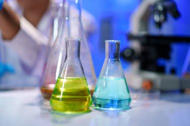 Laboratuvar deneyleri, ölçümler ve profesyonel bir laboratuvarda reaksiyonların gözlemlenmesi için düzenlenmiş kimyasal çözümler içeren cam şişeler..