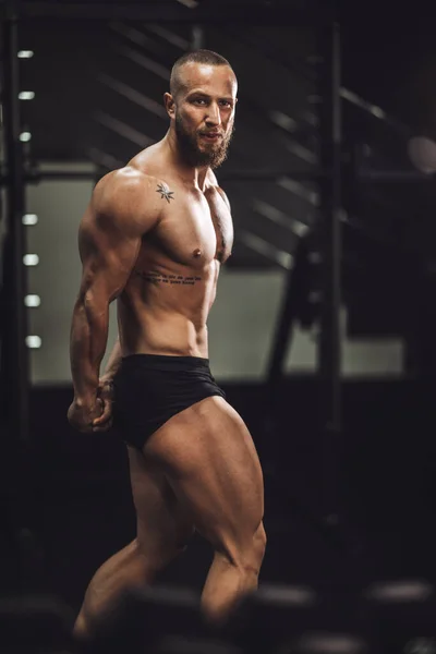 Foto Joven Musculoso Culturista Mostrando Sus Músculos Perfectos Mientras Posaba —  Fotos de Stock