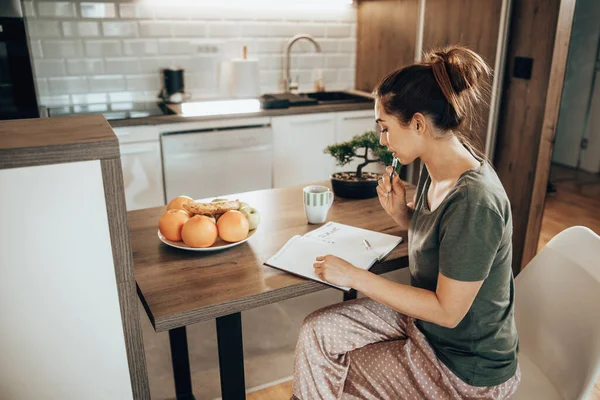 Young Woman Writing Notebook Making List While Enjoying Morning Coffee — 스톡 사진
