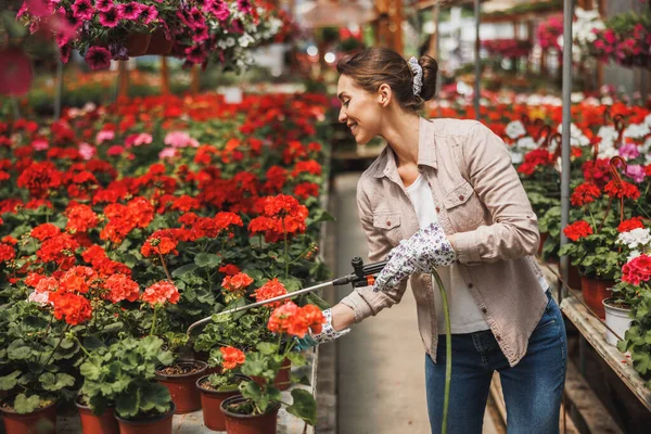 Young Woman Watering Flowers Caring Them Garden Center Plant Nursery — Zdjęcie stockowe