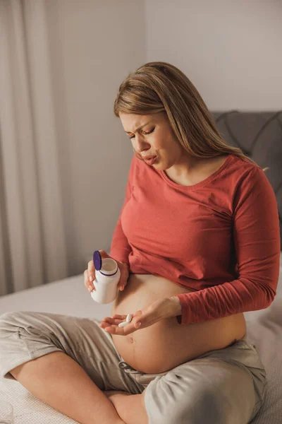 Unhappy Pregnant Woman Holding Medicine While Having Pain Bed Bedroom — Stock Photo, Image