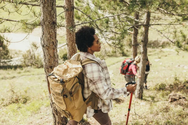 Mature black woman hiking through the mountains with her friends.