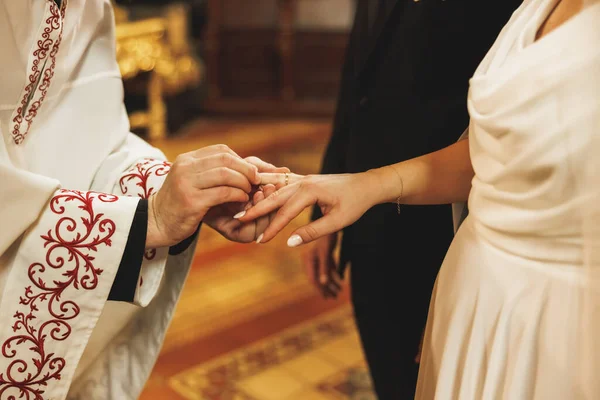 Exchange of wedding rings at a orthodox church wedding.