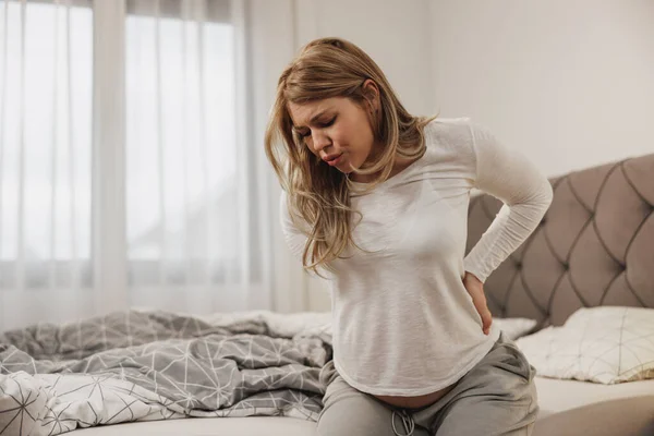 Pregnant Woman Breathing Holding Her Back Pain While Sitting Bed — Stock Photo, Image