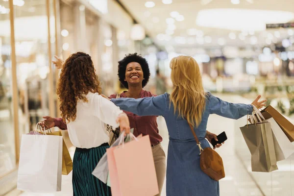 Stock image Beautiful smiling Black woman embracing her best friends in the city mall during reunion in a shopping spree.