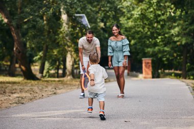 Mutlu çocuk parkta ailesinin yanına koşuyor.. 