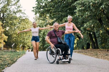 Mutlu bir aile parkta eğleniyor. Babam tekerlekli sandalyede.. 
