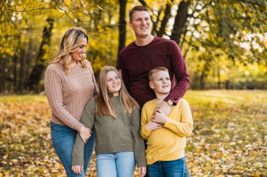 Güzel bir sonbahar parkında güzel bir gün geçiren neşeli bir aile.. 