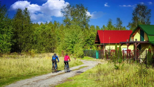 暖かい春の日に森の中で自転車に乗るカップル — ストック写真