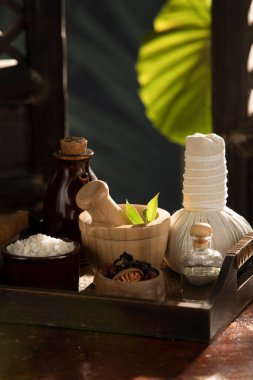 close up view of herb, salt, oil and Herbal Compress on color back.