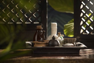 close up view of herb, salt, oil and Herbal Compress on color back.