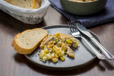 homemade salad with herring and fried potatoes