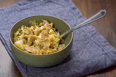 homemade salad with herring and fried potatoes