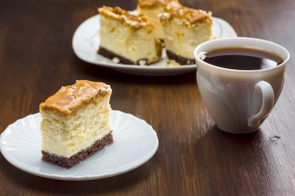 tasty dessert - a cup of coffee and a piece of homemade cheesecake with toffee topping