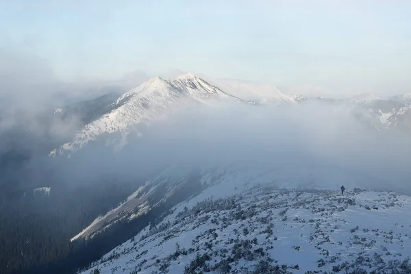 極端な冬のハイキングで尾根の頂上に雪のピークと男と冬の山の風景 — ストック写真
