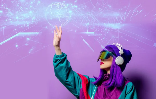 stock image Style woman in VR glasses and 80s tracksuit with headphones on violet background