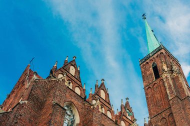 Gotik bir kilisenin karmaşık cephesi parlak mavi bir gökyüzüne karşı kurulmuştur, wroclaw, Polonya