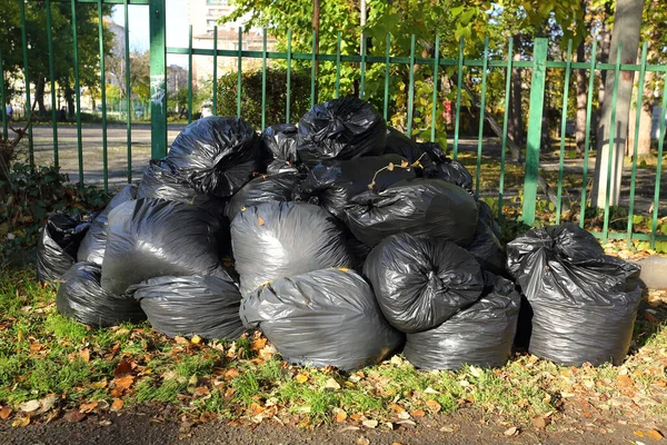 a pile of full trash bags