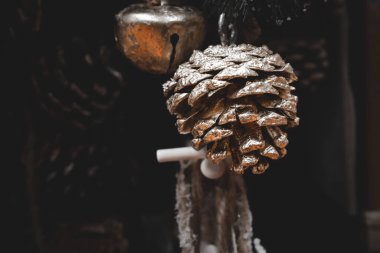 Güzel noel süslemeleri. Bej arka planda kahverengi koniler. Yakın planda.