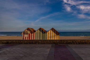 beautiful peaceful seaside landscape with three colorful wooden houses beach and vacation