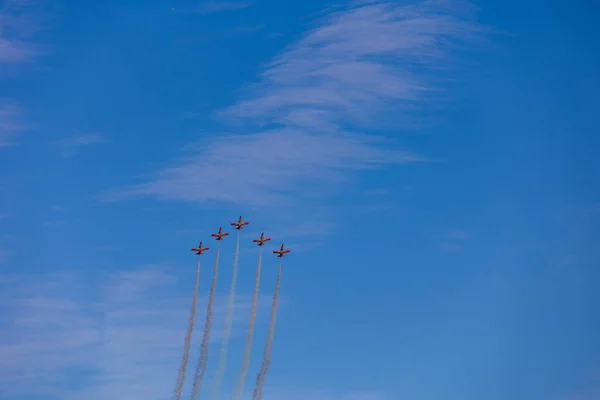 beautiful flight of five cessna planes over alicante smoke spanish flag against the blue sky spain
