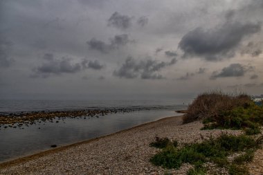 beautiful landscape empty rocky beach on a cloudy day spain