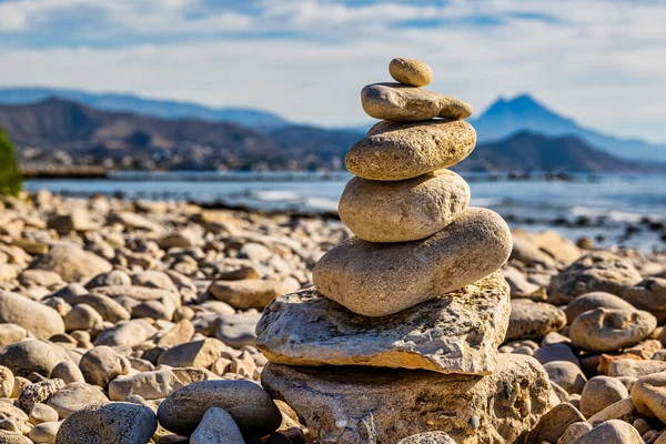 stock image stones stacked in towers on a pebble beach landscape 