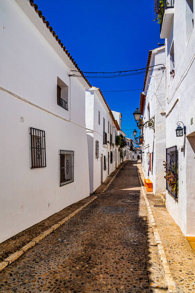 Beautiful urban narrow street in the Spanish city of Altea on a summer day