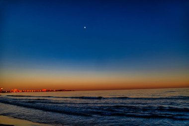 beautiful playa del postiguet alicante spain after sunset clipart