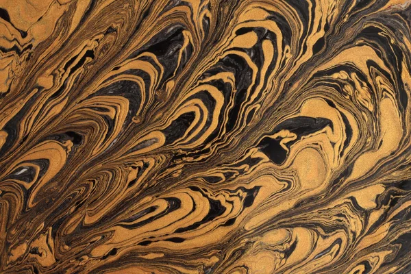Art flow pour oil and acrylic color painting blot wall. Abstract swirl black and gold texture background.