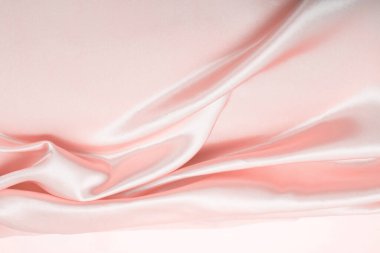 Beige pink nacre wave fabric silk. Abstract texture horizontal copy space background.