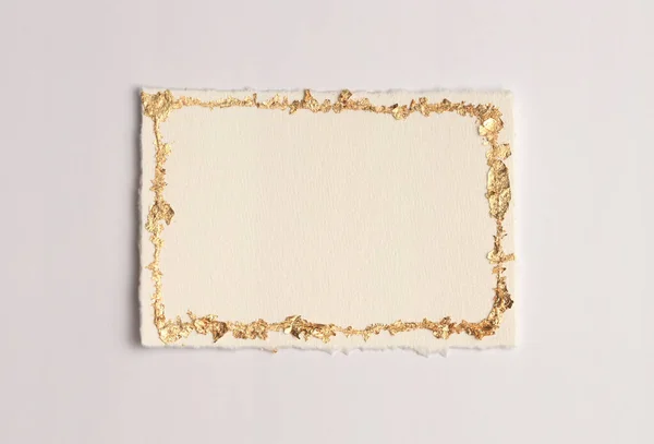 stock image Gold (bronze) glitter empty canvas frame on beige gray paper background. Abstract copy space texture.