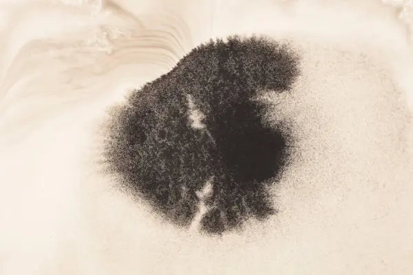 米色纹理纸背景上的黑褐色油墨水彩斑斑斑 — 图库照片