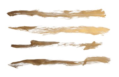 Grunge Altın mürekkep renginde fırça darbesi lekesi beyaz arkaplanda leke. 