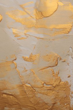 Sanat yağı ve akrilik leke bezi duvar boyası. Soyut altın, bej rengi leke fırça darbesi modelleme kil kabartma tahıl dokusu arka planı.