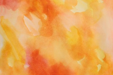 Islak kağıt desenli arka planda mürekkep rengi el boyası lekesi çizilmiş. Kırmızı, turuncu, sarı.