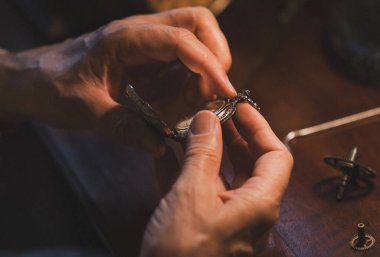 Kapalı - ahşap bir arka planda saat yapmak insanın elleri