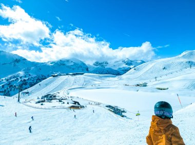 Obertauern, Salzburg area, Austria - Ski resort, hut, skiers and slope in Austrian Alps clipart
