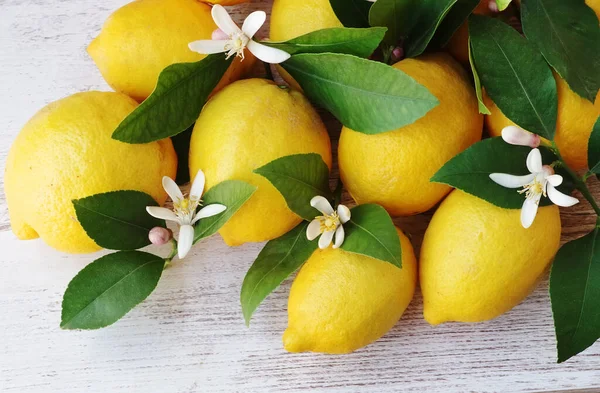 Bund Gelber Zitronen Und Blumen Auf Dem Tisch Stockbild