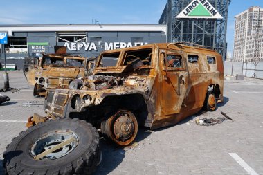 KYIV, UKRAINE, APRIL 15, 2022: Cars burned by russian missile. Missile destroyed shopping center Retroville on March 20. Terror and genocide of Ukrainian people. Russia - state of sponsor of terrorism