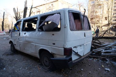 KYIV, UKRAINE, MARCH 20, 2022: Russian missile destroyed minibus and damaged houses in Kyiv on March 18, 2022.Russian aggression, after bombing, war in Ukraine, terror and genocide of Ukrainian people