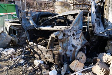KYIV, UKRAINE, MARCH 20, 2022: After bombing. Cars burned by russian missile in Kyiv city on March 18, 2022. War in Ukraine. Russia - terrorist country. Terror and genocide of Ukrainian people