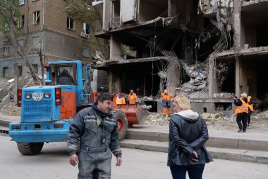 KYIV, UKRAINE, APRIL 29, 2022: Workers clear rubble after bombing. Dwelling house damaged by russian missile on April 28, 2022. War in Ukraine. Terror and genocide of Ukrainian people