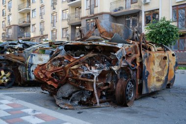IRPIN, UKRAINE, JUNE 6, 2022: After bombing. Russian terrorist army burned cars, dwelling houses and killed people in Irpin town, Kyiv Oblast on March 2022. Terror and genocide of Ukrainian people