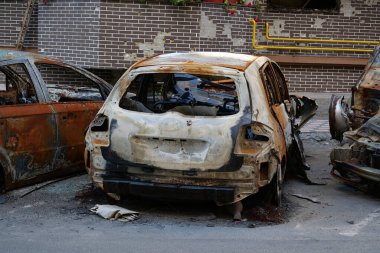 IRPIN, UKRAINE, JUNE 6, 2022: After bombing. Russian terrorist army burned cars, dwelling houses and killed people in Irpin town, Kyiv Oblast on March 2022. Terror and genocide of Ukrainian people