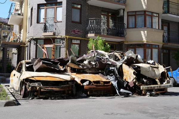 IRPIN, UKRAINE, JUNE 6, 2022: After bombing. Russian terrorist army burned cars, dwelling houses and killed people in Irpin town, Kyiv Oblast on March 2022. Terror and genocide of Ukrainian people