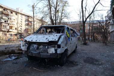 KYIV, UKRAINE, MARCH 20, 2022: Russian missile destroyed minibus and damaged houses in Kyiv on March 18. Russian aggression, after bombing, war in Ukraine, terror and genocide of Ukrainian people